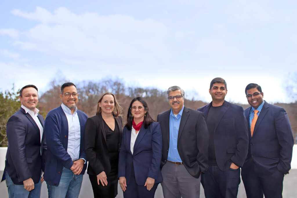 Group of professional MBA students standing outside smiling 